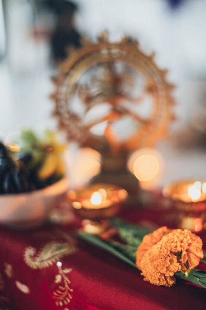 pexels photo 2072581 A vibrant traditional Hindu offering setup with candles, flowers, and cultural elements captured in a warm setting.