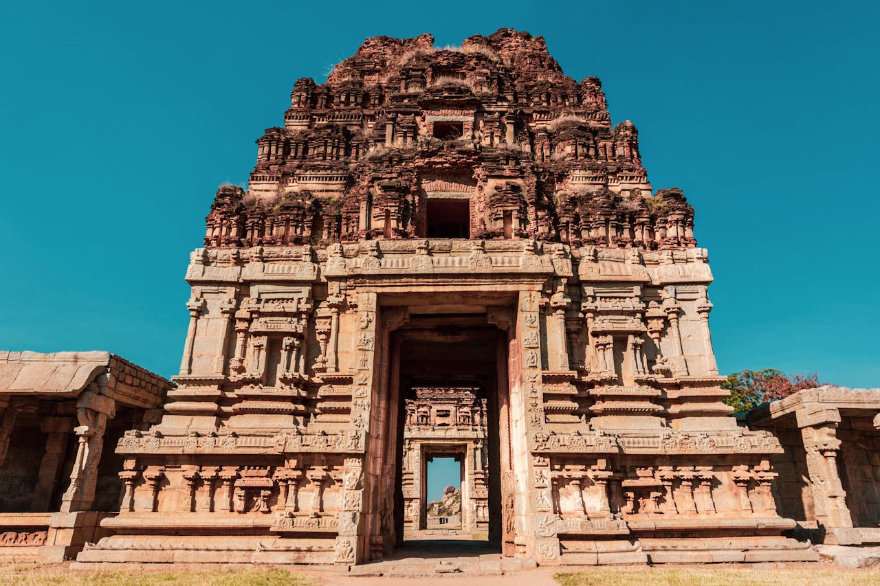 gallery-5 Explore the stunning stone-carved facade of a historic temple in Hampi, a UNESCO World Heritage Site.